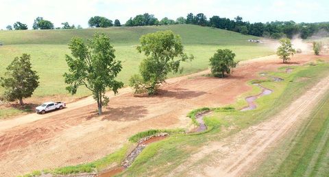 Aerial view of a newly constructed meandering stream channel through pasture at the Porterhouse Valley Mitigation Bank in Tennessee