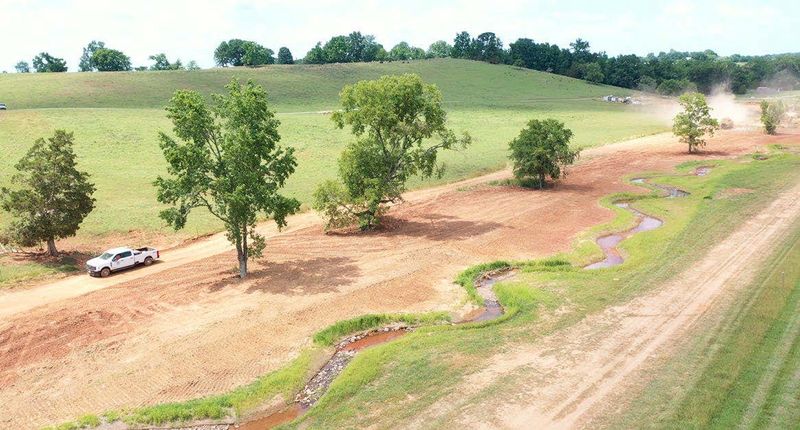 Aerial view of a newly constructed meandering stream channel through pasture at the Porterhouse Valley Mitigation Bank in Tennessee